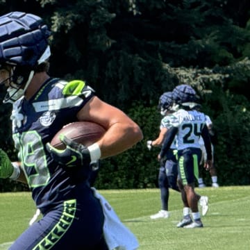 Seattle Seahawks receiver Jake Bobo runs after the catch during a passing drill at training camp.