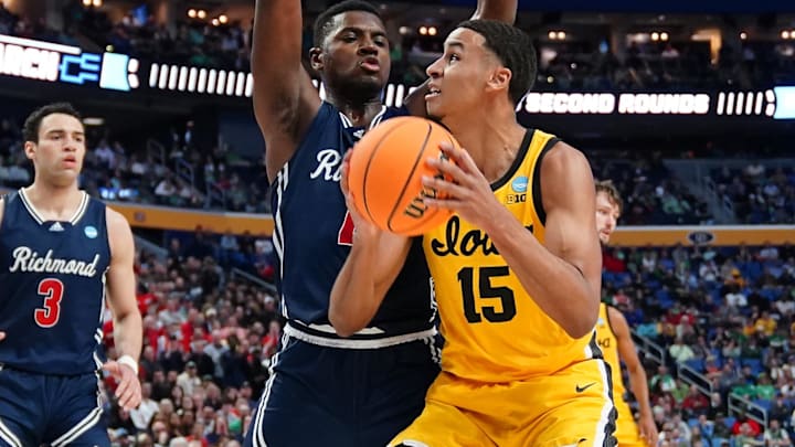 Mar 17, 2022; Buffalo, NY, USA; Iowa Hawkeyes forward Keegan Murray (15) controls the ball against Richmond Spiders forward Nathan Cayo (left) in the second half during the first round of the 2022 NCAA Tournament at KeyBank Center. Mandatory Credit: Gregory Fisher-Imagn Images