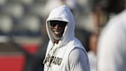 Sep 12, 2025; Houston, Texas, USA; Colorado Buffaloes head coach Deion Sanders smiles on the field before the game against the Houston Cougars at TDECU Stadium.