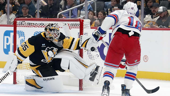Oct 9, 2024; Pittsburgh, Pennsylvania, USA;  Pittsburgh Penguins goaltender Tristan Jarry (35) makes a glove save against New York Rangers center Vincent Trocheck (16) during the third period at PPG Paints Arena.