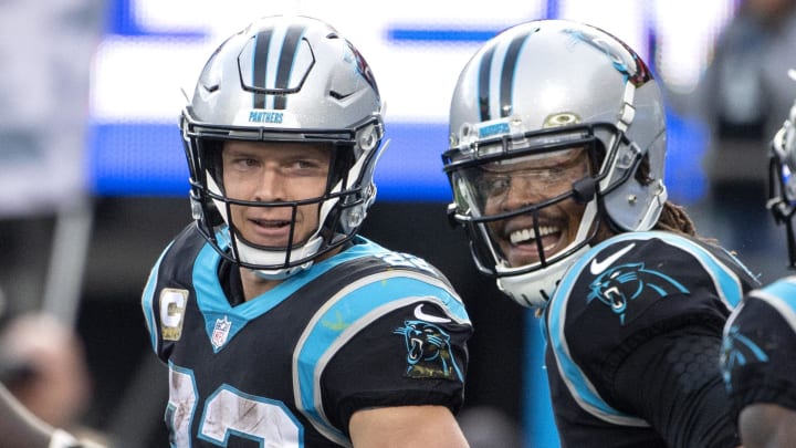 Nov 21, 2021; Charlotte, North Carolina, USA; Carolina Panthers running back Christian McCaffrey (22) with quarterback Cam Newton (1) after scoring a touchdown in the fourth quarter at Bank of America Stadium. Mandatory Credit: Bob Donnan-USA TODAY Sports