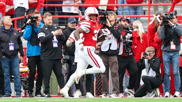 Kenneth Williams peeks back during his 95-yard kickoff return touchdown run.