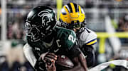 Michigan defensive back TJ Metcalf (7) tackles Michigan State quarterback Aidan Chiles (2) during the second half at Spartan Stadium in East Lansing on Saturday, October 25, 2025.
