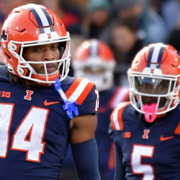 Nov 16, 2024; Champaign, Illinois, USA;  Illinois Fighting Illini defensive back Xavier Scott (14) and Illinois Fighting Illini defensive back Torrie Cox Jr. (5) during the first half at Memorial Stadium. Mandatory Credit: Ron Johnson-Imagn Images