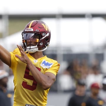 Jul 26, 2024; Ashburn, VA, USA; Washington Commanders quarterback Jayden Daniels (5) passes the ball on day three of training camp at Commanders Park. Mandatory Credit: Geoff Burke-USA TODAY Sports