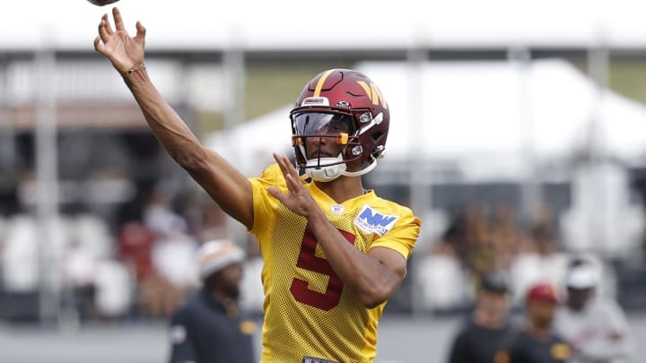 Jul 26, 2024; Ashburn, VA, USA; Washington Commanders quarterback Jayden Daniels (5) passes the ball on day three of training camp at Commanders Park. Mandatory Credit: Geoff Burke-USA TODAY Sports