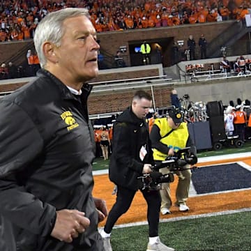 Oct 8, 2022; Champaign, Illinois, USA;  Iowa Hawkeyes head coach Kirk Ferentz runs out on the field before the kickoff against the Illinois Fighting Illini at Memorial Stadium. Mandatory Credit: Ron Johnson-Imagn Images