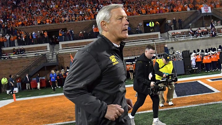 Oct 8, 2022; Champaign, Illinois, USA;  Iowa Hawkeyes head coach Kirk Ferentz runs out on the field before the kickoff against the Illinois Fighting Illini at Memorial Stadium. Mandatory Credit: Ron Johnson-Imagn Images