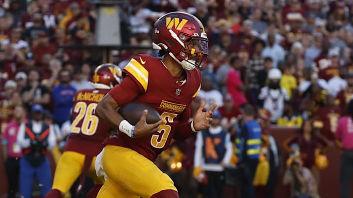 Oct 20, 2024; Landover, Maryland, USA; Washington Commanders quarterback Jayden Daniels (5) runs with the ball against the Carolina Panthers during the first quarter at Northwest Stadium. Mandatory Credit: Geoff Burke-Imagn Images