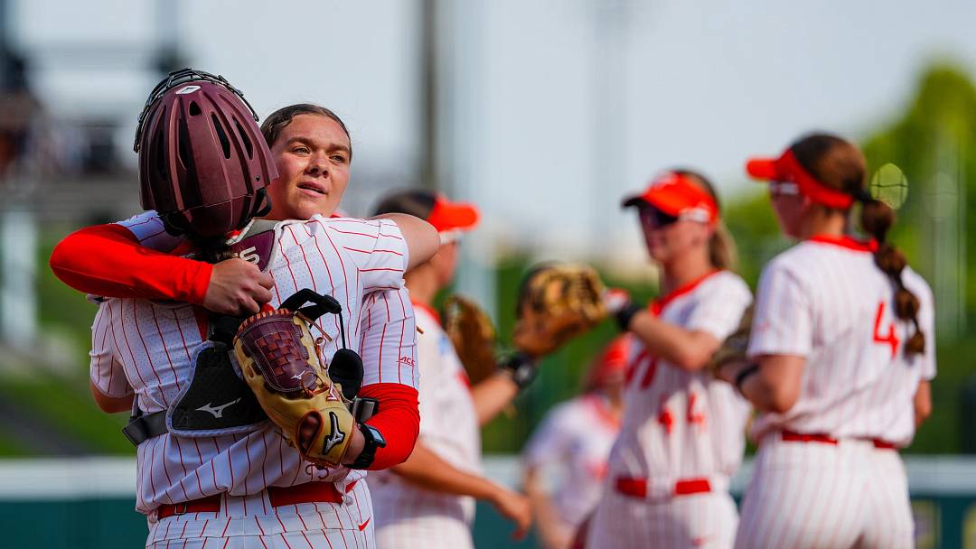 Avery Layton and catcher Zoe Yaeger hug after an outing in the circle.