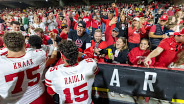 Nebraska players, including quarterback Dylan Raiola, celebrate with Huskers fans after a win at Maryland.