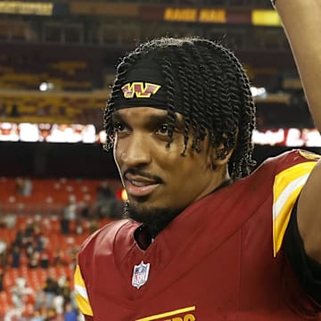 Dec 29, 2024; Landover, Maryland, USA; Washington Commanders quarterback Jayden Daniels (5) celebrates while leaving the field after the Commanders' game against the Atlanta Falcons at Northwest Stadium. Mandatory Credit: Geoff Burke-Imagn Images