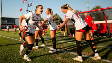 Nebraska soccer players cheer during team introductions.