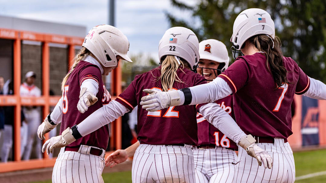 Three Hokies prepare to embrace Jordan Lynch (16) after she homered against Syracuse.