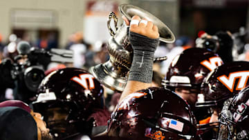 Nov 30, 2024; Blacksburg, VA; USA; Virginia Tech hoisting the Commonwealth Cup After 37-17 W over Virginia