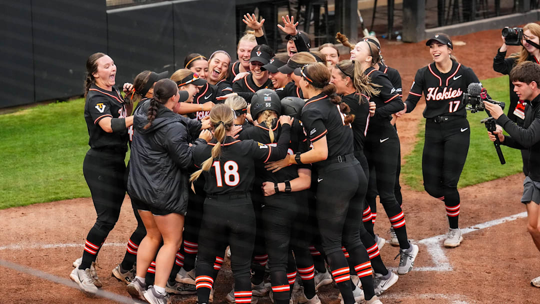 The Hokies gather at the plate in celebration.