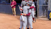 Cori McMillan (2) hugs her teammate Michelle Chatfield at home plate.