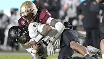 Nov 1, 2025; Tallahassee, Florida, USA; Wake Forest Demon Deacons quarterback Robby Ashford (2) is tackled by Florida State Seminoles defensive back Shyheim Brown (1) during the second half at Doak S. Campbell Stadium. Mandatory Credit: Melina Myers-Imagn Images