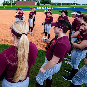 Hokies gather around for a talk in practice ahead of their regional matchup.