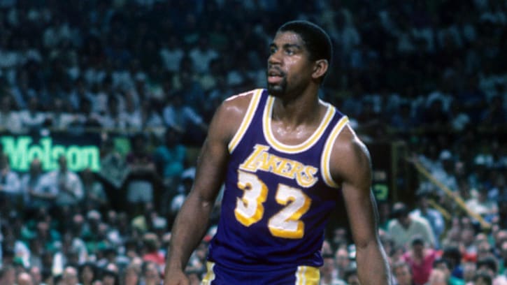 Jun 1984; Boston, MA, USA; FILE PHOTO; Los Angeles Lakers guard Magic Johnson (32) is defended by