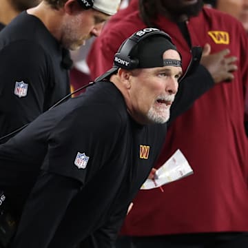 Aug 8, 2025; Foxborough, Massachusetts, USA; Washington Commanders head coach Dan Quinn reacts during the first half against the New England Patriots at Gillette Stadium. Mandatory Credit: Paul Rutherford-Imagn Images