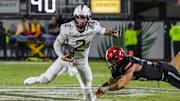 Aug 28, 2025; Orlando, Florida, USA; UCF Knights quarterback Tayven Jackson (2) avoids a tackle during the second quarter against the Jacksonville State Gamecocks at Acrisure Bounce House. Mandatory Credit: Mike Watters-Imagn Images