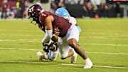 Sep 13, 2025; Blacksburg, Va. ODU linebacker Jeremy Mack Jr. (4) strips the ball from Virginia Tech quarterback Kyron Drones (1).