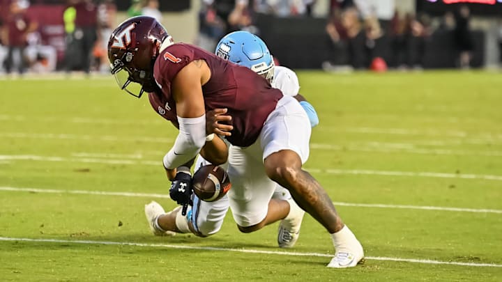 Sep 13, 2025; Blacksburg, Va. ODU linebacker Jeremy Mack Jr. (4) strips the ball from Virginia Tech quarterback Kyron Drones (1). Sep 13, 2025; Blacksburg, Va. ODU linebacker Jeremy Mack Jr. (4) strips the ball from Virginia Tech quarterback Kyron Drones (1).