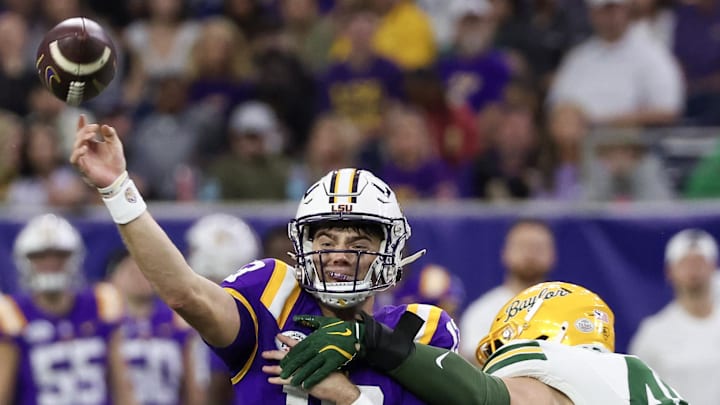 Dec 31, 2024; Houston, TX, USA;  LSU Tigers quarterback Garrett Nussmeier (13) is hit by Baylor Bears linebacker Josh White (44) in the second half at NRG Stadium. Mandatory Credit: Thomas Shea-Imagn Images