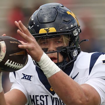 Nov 1, 2025; Houston, Texas, USA; West Virginia Mountaineers quarterback Scotty Fox Jr. (15) takes a snap against the Houston Cougars  in the first half at TDECU Stadium. Mandatory Credit: Thomas Shea-Imagn Images