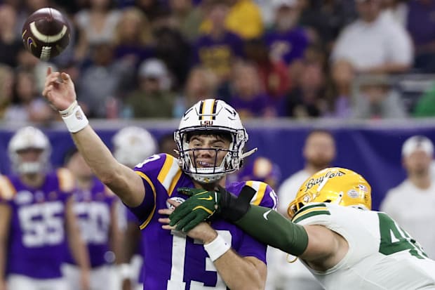 LSU Tigers quarterback Garrett Nussmeier (13) is hit by Baylor Bears linebacker Josh White (44) in the second half.