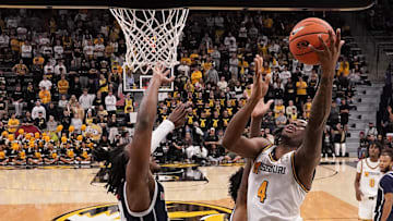 Nov 8, 2024; Columbia, Missouri, USA; Missouri Tigers guard Marcus Allen (4) shoots a layup as Howard Bison guard Bryce Harris (34) defends during the second half at Mizzou Arena. Mandatory Credit: Denny Medley-Imagn Images