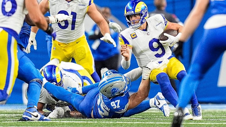 Los Angeles Rams quarterback Matthew Stafford (9) is sacked by Detroit Lions defensive end Aidan Hutchinson (97).