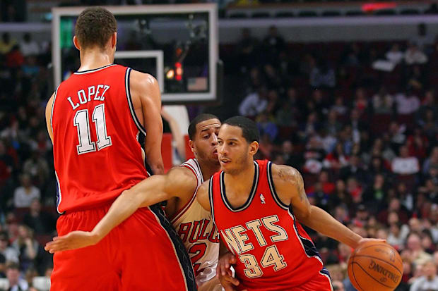 Nets guard Devin Harris (34) drives past Bulls guard Jannero Pargo (2) while being screened by Nets center Brook Lopez.