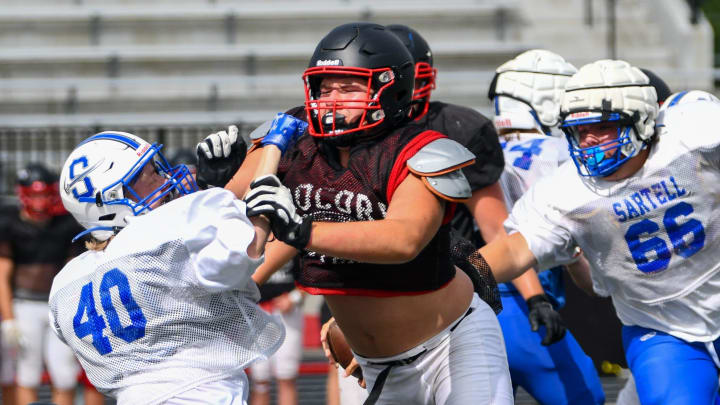 ROCORI's Andrew Trout blocks a Sartell defender during a scrimmage August 26 at home.