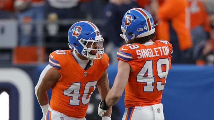 Jan 4, 2026; Denver, Colorado, USA; Denver Broncos linebacker Justin Strnad (40) celebrates with linebacker Alex Singleton (49) after a sack during the second half against the Los Angeles Chargers at Empower Field at Mile High. Mandatory Credit: Isaiah J. Downing-Imagn Images