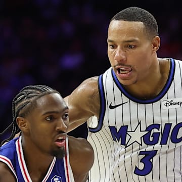 Philadelphia 76ers guard Tyrese Maxey dribbles past Orlando Magic guard Desmond Bane.