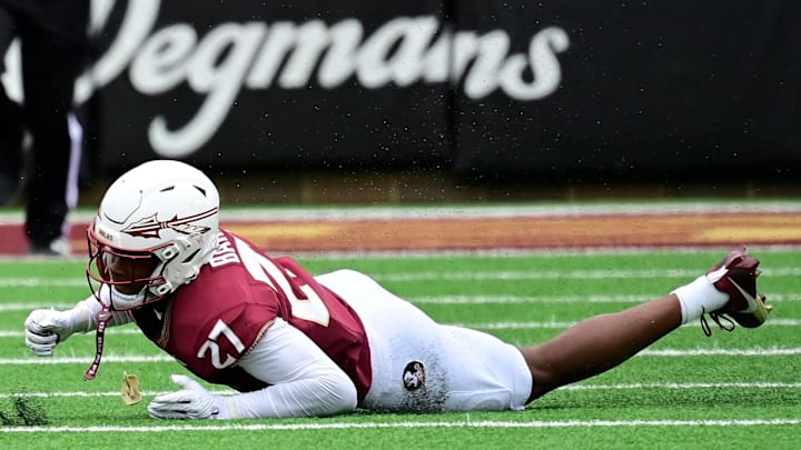 Sep 16, 2023; Chestnut Hill, Massachusetts, USA; Boston College Eagles quarterback Thomas Castellanos (1) breaks a tackle by Florida State Seminoles defensive back Ashlynd Barker (27) during the first half at Alumni Stadium. Mandatory Credit: Eric Canha-Imagn Images