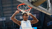 Feb 19, 2025; Chapel Hill, North Carolina, USA; North Carolina Tar Heels forward James Brown (2) scores as North Carolina State Wolfpack guard Dontrez Styles (3) defends in the second half at Dean E. Smith Center. Mandatory Credit: Bob Donnan-Imagn Images