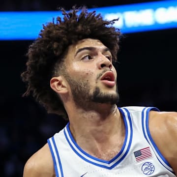 Nov 4, 2025; Charlotte, North Carolina, USA;  Duke Blue Devils forward Cameron Boozer (12) battles for position against Texas Longhorns forward Nic Codie (10) during the first quarter at the Dick Vitale’s Invitational game at Spectrum Center. Mandatory Credit: Cory Knowlton-Imagn Images