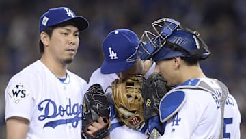 Dodgers pitcher Kenta Maeda (left) talks with catcher Austin Barnes (15) and infielder Chase Utley (26) in the 7th inning against the Houston Astros in game six of the 2017 World Series at Dodger Stadium. 