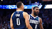 Apr 5, 2024; Dallas, Texas, USA;  Dallas Mavericks guard Kyrie Irving (11) celebrates with Dallas Mavericks guard Dante Exum (0) in fron tof Golden State Warriors guard Chris Paul (3) after the game at American Airlines Center. Mandatory Credit: Kevin Jairaj-Imagn Images