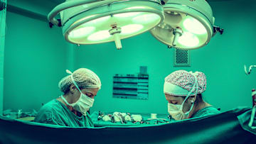 Two people performing surgery