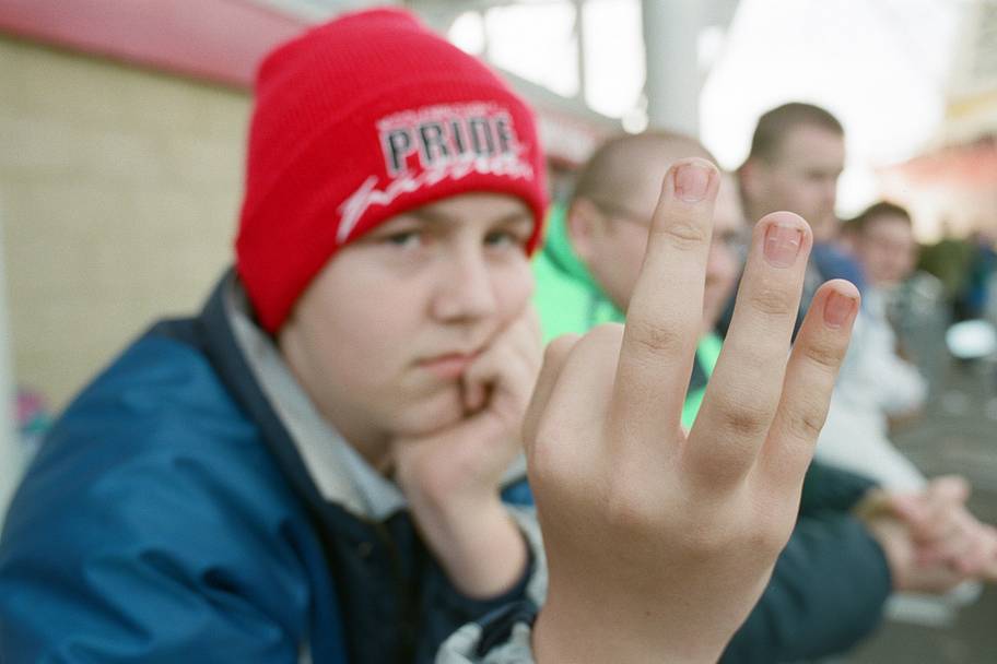 Middlesbrough fan holds up three fingers.