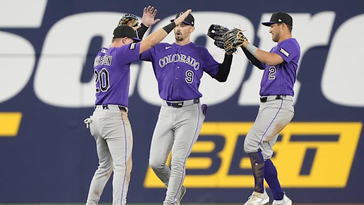 Apr 1, 2026; Toronto, Ontario, CAN; Colorado Rockies left fielder Troy Johnston (20) and center fielder Brenton Doyle (9)  and right fielder Tyler Freeman (2) celebrate a win over the Toronto Blue Jays after the tenth inning at Rogers Centre. Mandatory Credit: John E. Sokolowski-Imagn Images