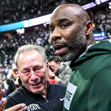 Michigan State's head coach Tom Izzo, center, hugs former player Mateen Cleaves, right, after the Spartans win over Oregon on Saturday, Feb. 8, 2025, at the Breslin Center East Lansing. Former player Mo Peterson, left, look on.