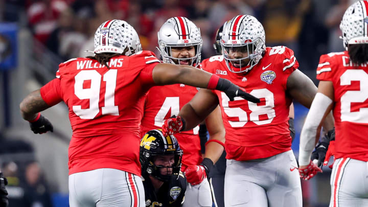 Dec 29, 2023; Arlington, TX, USA;  Ohio State Buckeyes defensive tackle Tyleik Williams (91) and Ohio State Buckeyes defensive tackle Ty Hamilton (58) celebrate after tackling Missouri Tigers quarterback Brady Cook (12) during the first half at AT&T Stadium. Mandatory Credit: Kevin Jairaj-USA TODAY Sports