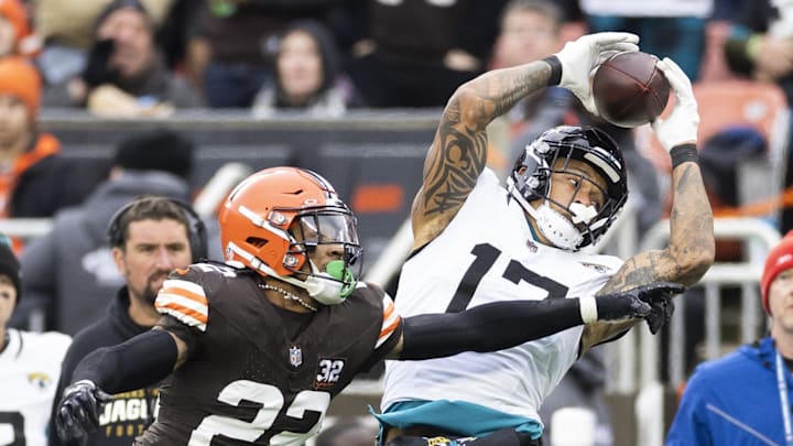 Dec 10, 2023; Cleveland, Ohio, USA; Jacksonville Jaguars tight end Evan Engram (17) makes a reception under coverage by Cleveland Browns safety Grant Delpit (22) during the second quarter at Cleveland Browns Stadium. Mandatory Credit: Scott Galvin-Imagn Images