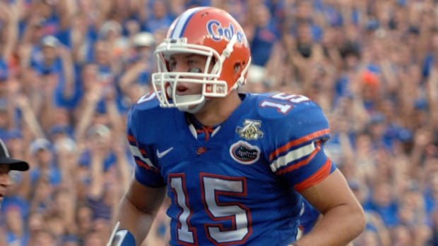 FILE | Florida quarterback Tim Tebow (15) runs 5 yards for a touchdown with 11:25 left in the fourth quarter in a college foo