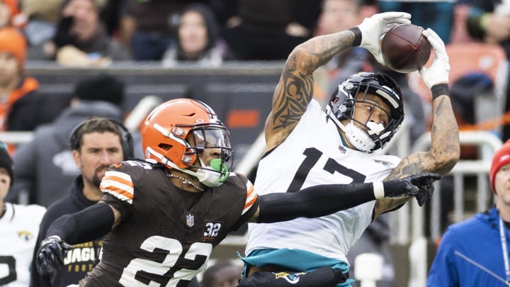 Dec 10, 2023; Cleveland, Ohio, USA; Jacksonville Jaguars tight end Evan Engram (17) makes a reception under coverage by Cleveland Browns safety Grant Delpit (22) during the second quarter at Cleveland Browns Stadium. Mandatory Credit: Scott Galvin-USA TODAY Sports